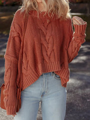 Chunky oversized rust cable-knit sweater with crew neck and cropped hem.