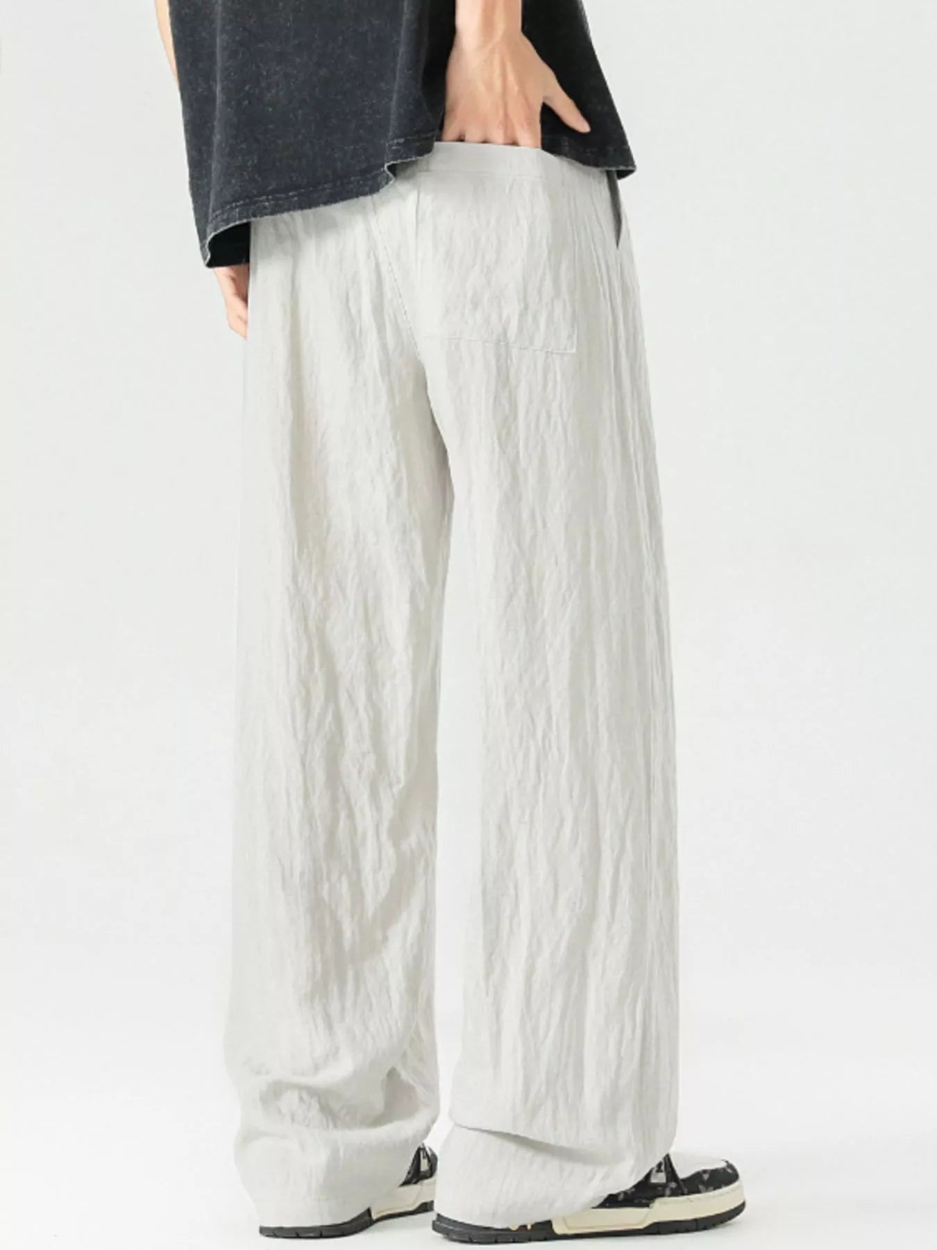 Lightweight wide-leg trousers in light gray with a drawstring waist and pockets.
