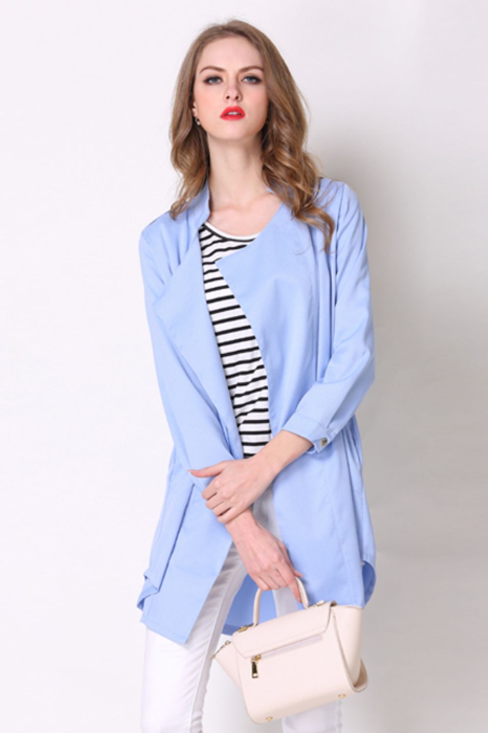Light blue drape-front trench coat with shoulder detailing and buttoned cuffs.