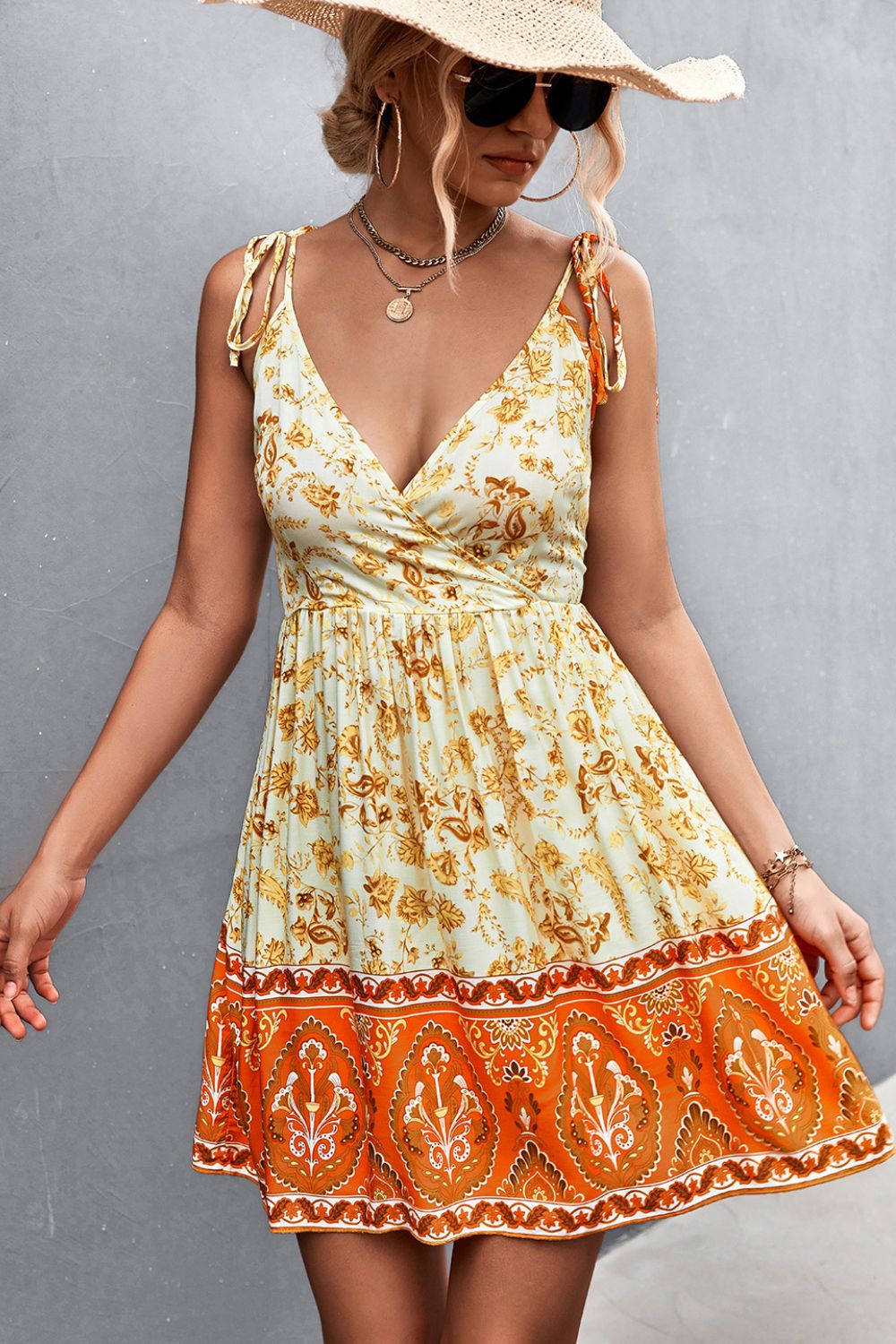 Bohemian print tie-strap mini dress in light yellow with orange border detail