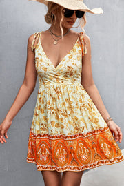 Bohemian print tie-strap mini dress in light yellow with orange border detail