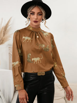 Caramel leopard print keyhole neck blouse with mock neck and long sleeves.