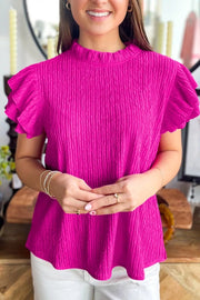 Textured ruffle trim blouse with mock neck in bright pink, featuring crinkle fabric and short sleeves.