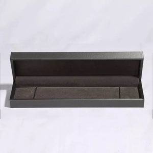 Empty dark grey jewelry box with plush lining for bracelets