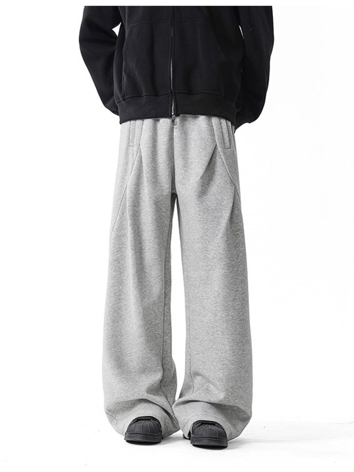 Men's gray wide-leg drawstring pants with a relaxed fit.