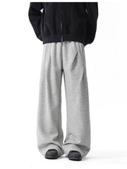 Men's gray wide-leg drawstring pants with a relaxed fit.
