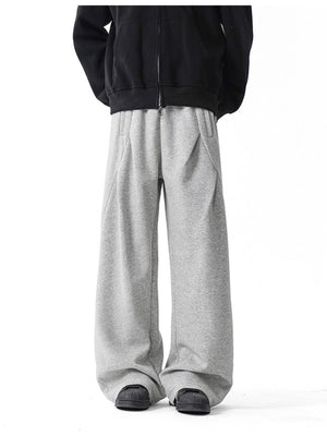 Men's gray wide-leg drawstring pants with a relaxed fit.