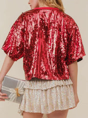 Red sequin t-shirt with short sleeves and a crew neck, styled with a gift.