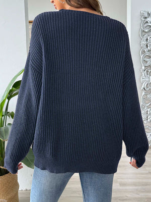 Dark navy ribbed knit sweater with off-shoulder neckline and contrast trim detail.
