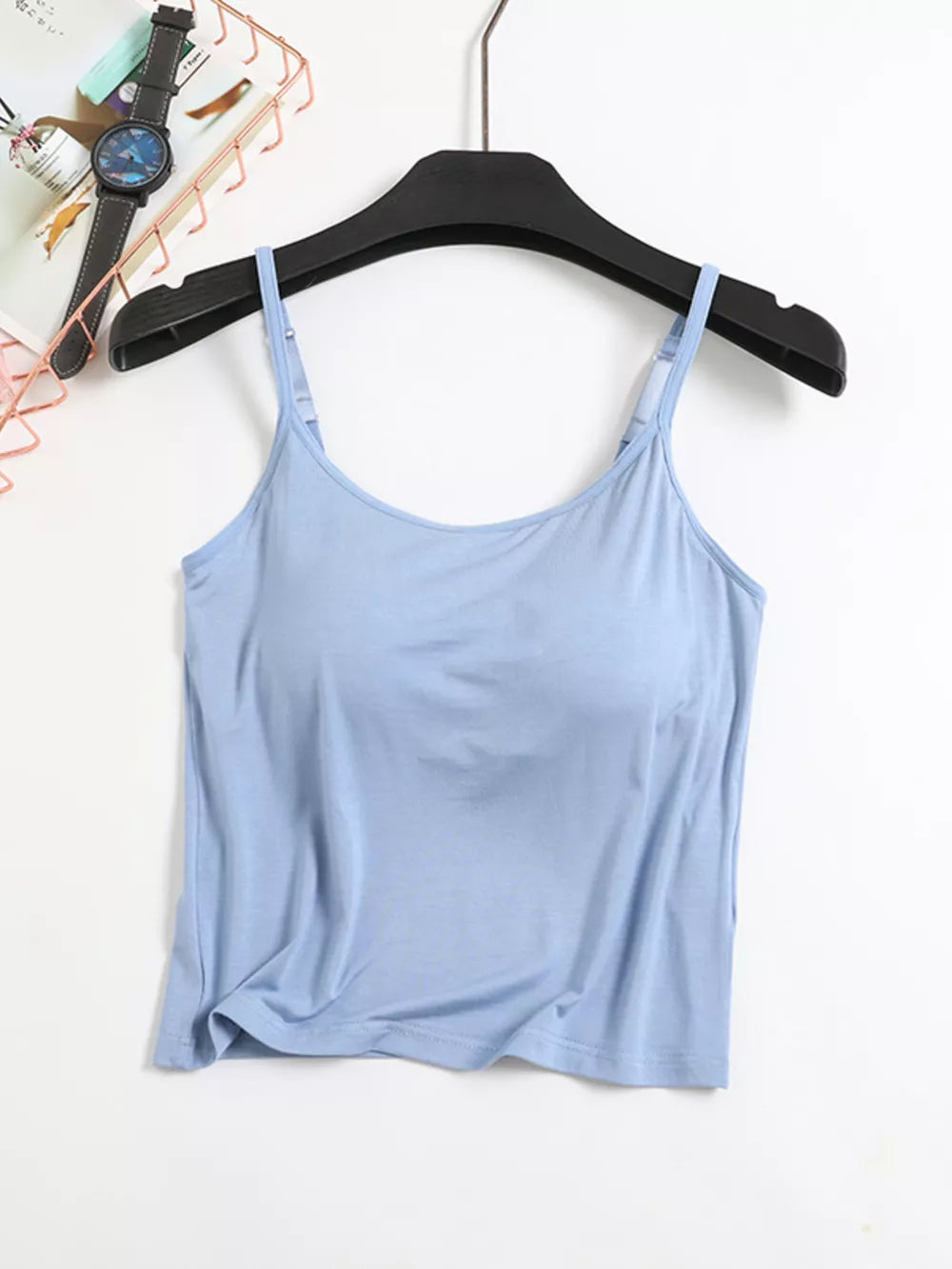 Light blue adjustable cami with thin straps and a scoop neckline.