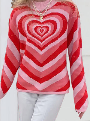 Heartbeat Stripe Mock Neck Knit sweater in pink and red stripes with a concentric heart pattern.