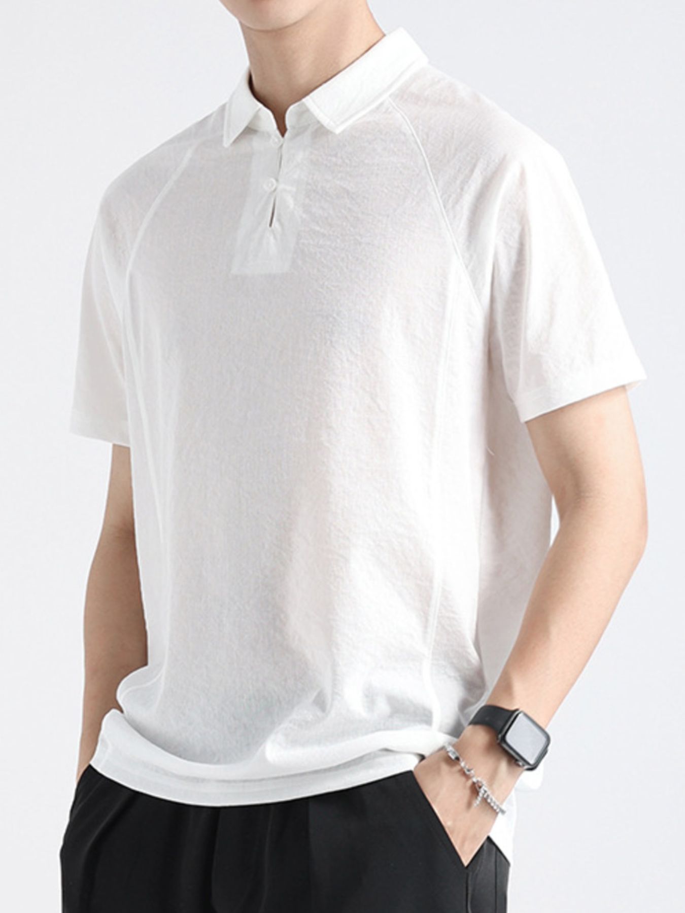 White cotton blend polo shirt with short sleeves and a two-button placket.