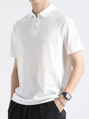 White cotton blend polo shirt with short sleeves and a two-button placket.