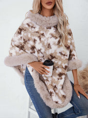 Faux fur trimmed camo poncho in chocolate with a fuzzy texture and relaxed fit.