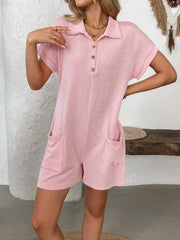 Pink ribbed knit romper with collar, buttons, and patch pockets.