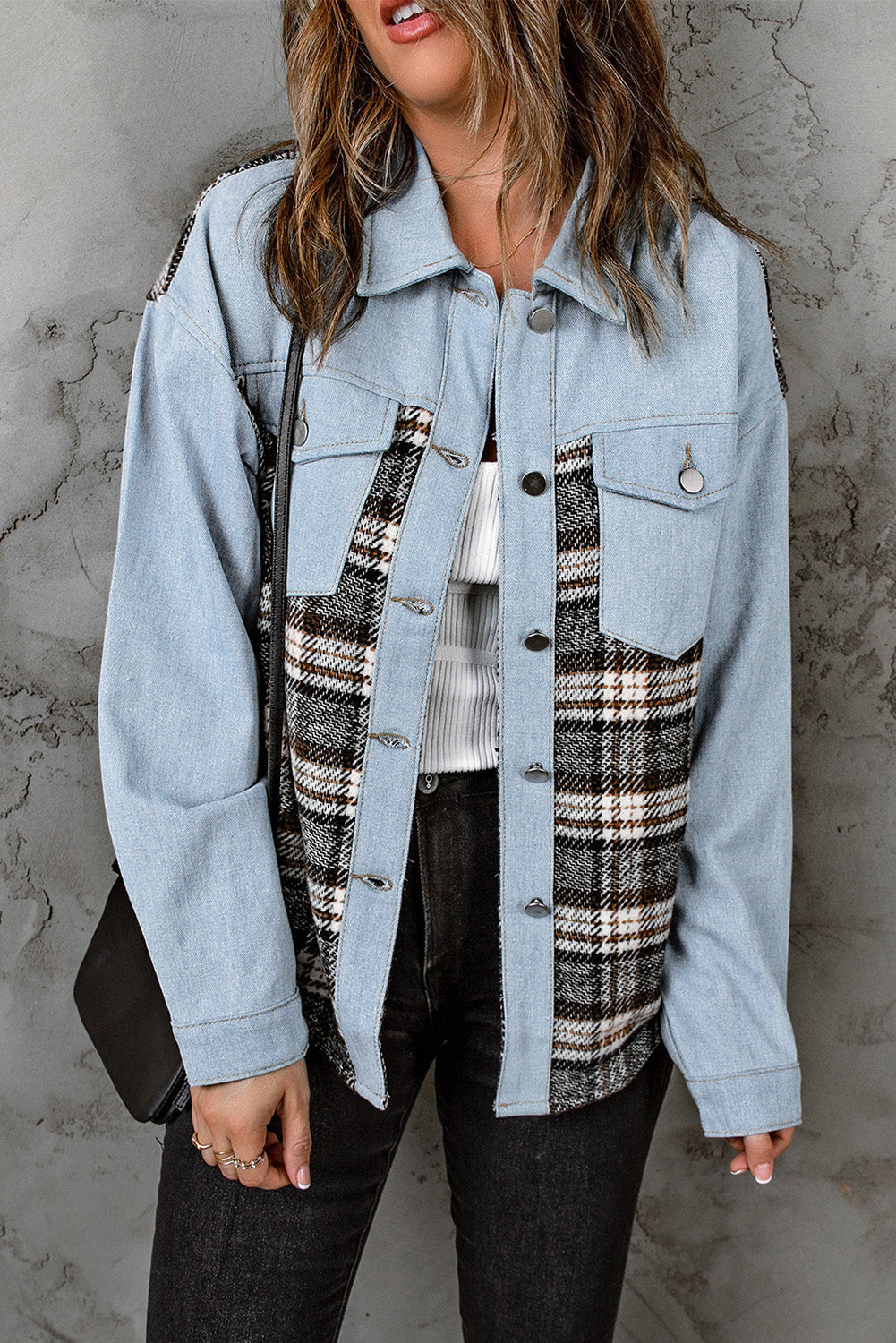 Light blue denim trucker jacket with plaid panels and button front.