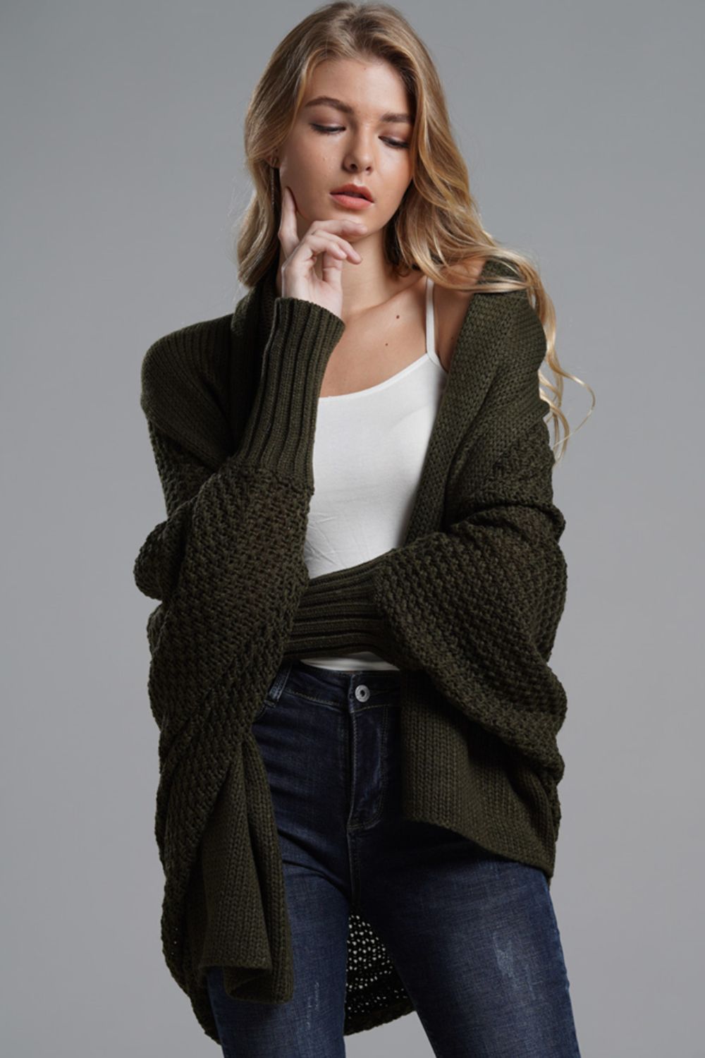 Olive green batwing knit cardigan with textured sleeves and drape front.