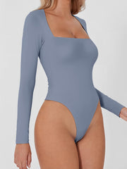Light blue long sleeve bodysuit with square neckline and high cut leg