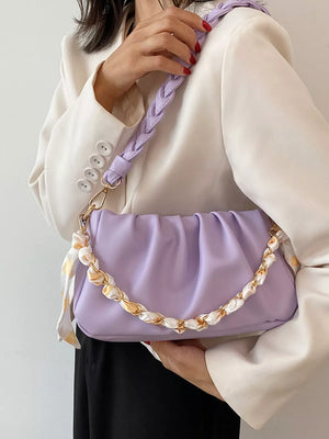 Purple ruched shoulder bag with braided strap and chain detail with scarf accent