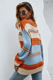 Deep plunge stripe knit pullover sweater in acrylic with orange, blue, and cream stripes.