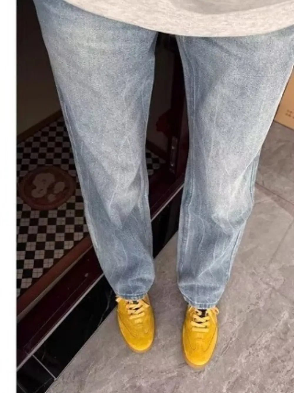 Men's light blue vintage wash straight-leg jeans with a relaxed fit.