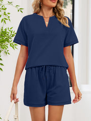 Navy blue loungewear shorts with drawstring waist and cuffed hem.