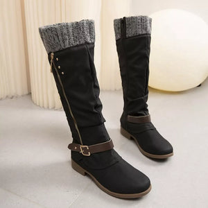 Black suede knee-high slouch boots with grey knit detail and buckle strap.