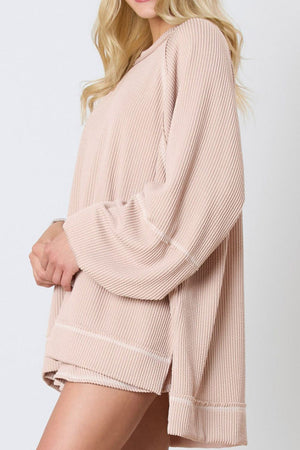 Apricot ribbed loungewear set with raglan sleeves and contrast stitching detail.