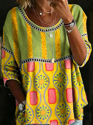 Bohemian floral openwork maternity t-shirt in yellow and green with patterned sleeves and neckline detail.