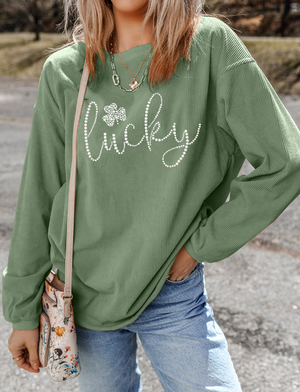 Sage corduroy sweatshirt with "Lucky" and shamrock embellishment