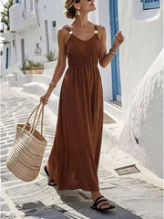 Brown V-neck sleeveless maxi dress with smocked waist and gold detail straps.