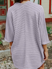 Textured ribbed sleeve cardigan in gray with cuffed sleeves.