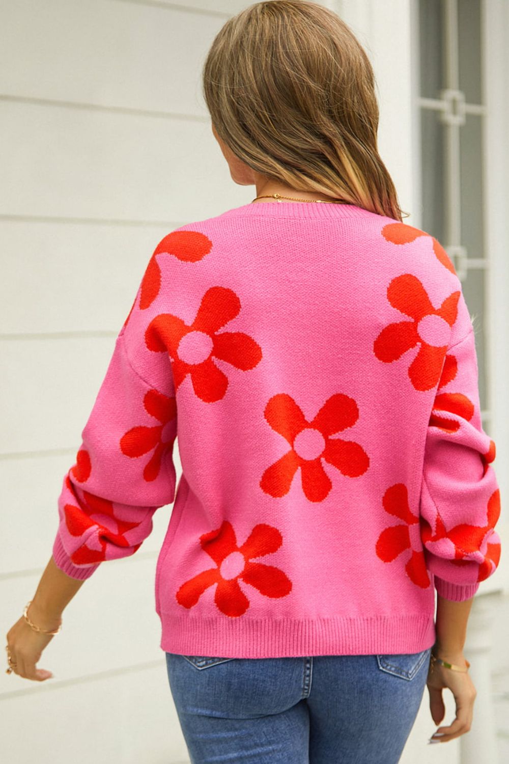 Pink acrylic sweater with red flower intarsia pattern, crew neck, long sleeves.