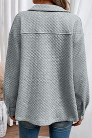 Quilted overshirt in Cloudy Blue with button cuffs and collar, shown from the back.