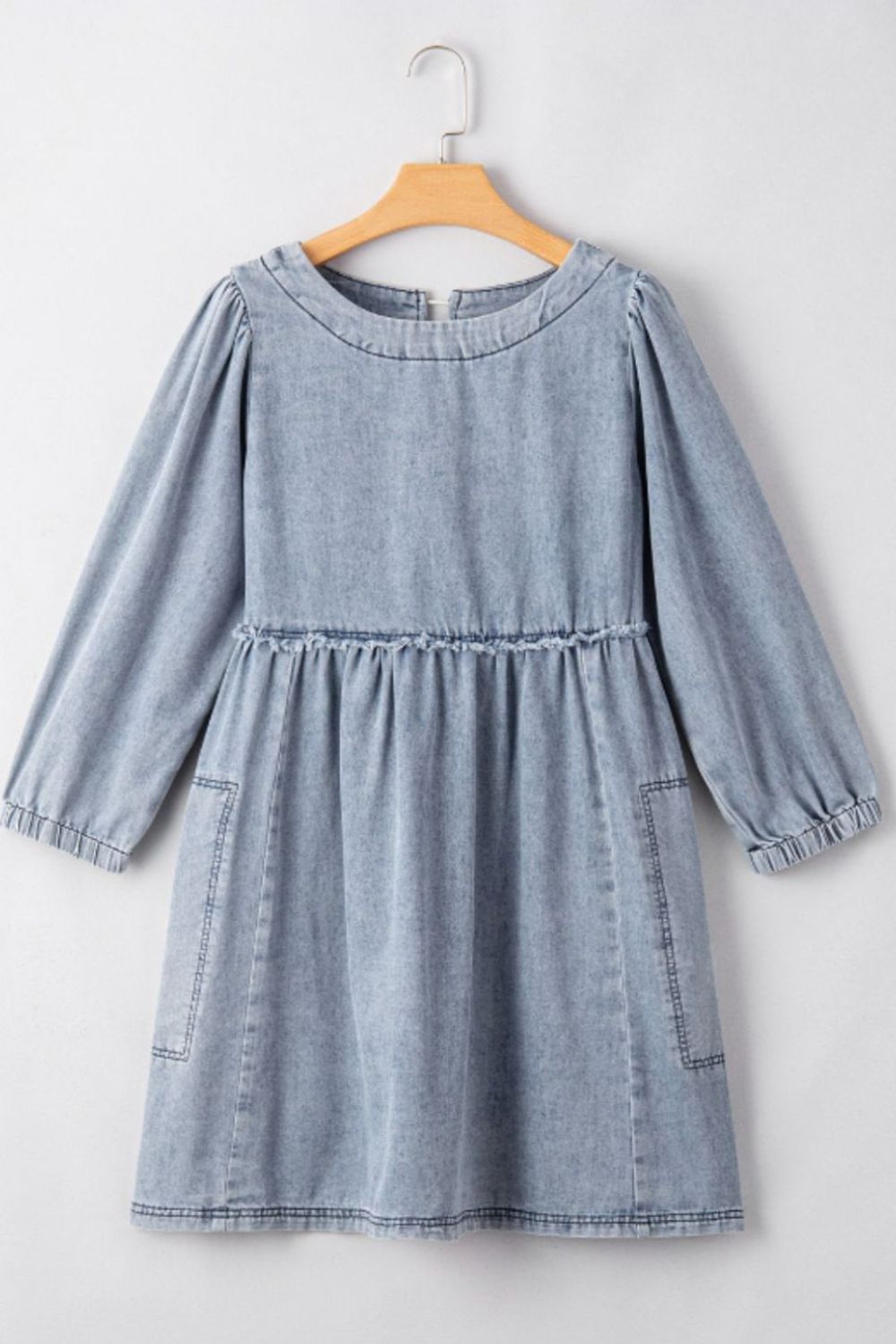Gathered waist denim mini dress in medium blue with balloon sleeves and pockets.