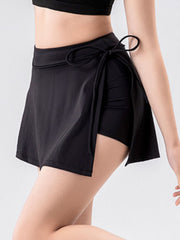 Black wrap-detail skort with side tie and built-in shorts.