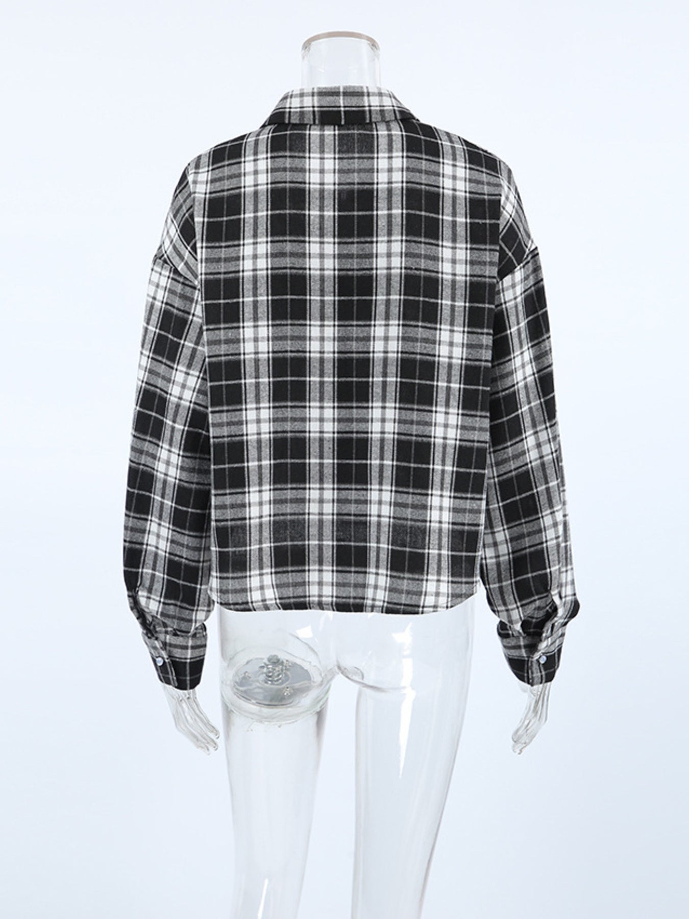 Oversized black and white plaid cotton button-up shirt with collar and cuffs.