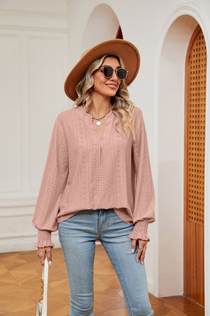 Blush pink eyelet detail poet sleeve blouse with V-neck and ruffled cuffs.