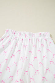 Pink bow print lounge set with elastic waistband and scalloped edges.
