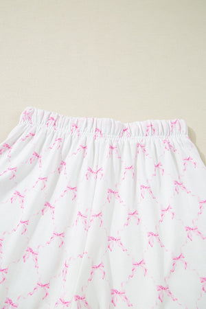 Pink bow print lounge set with elastic waistband and scalloped edges.
