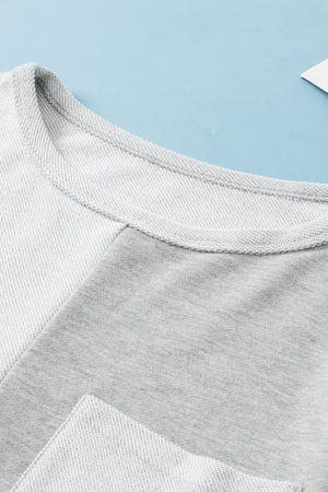 Colorblock sweatshirt in light gray with crew neck and pocket detail.