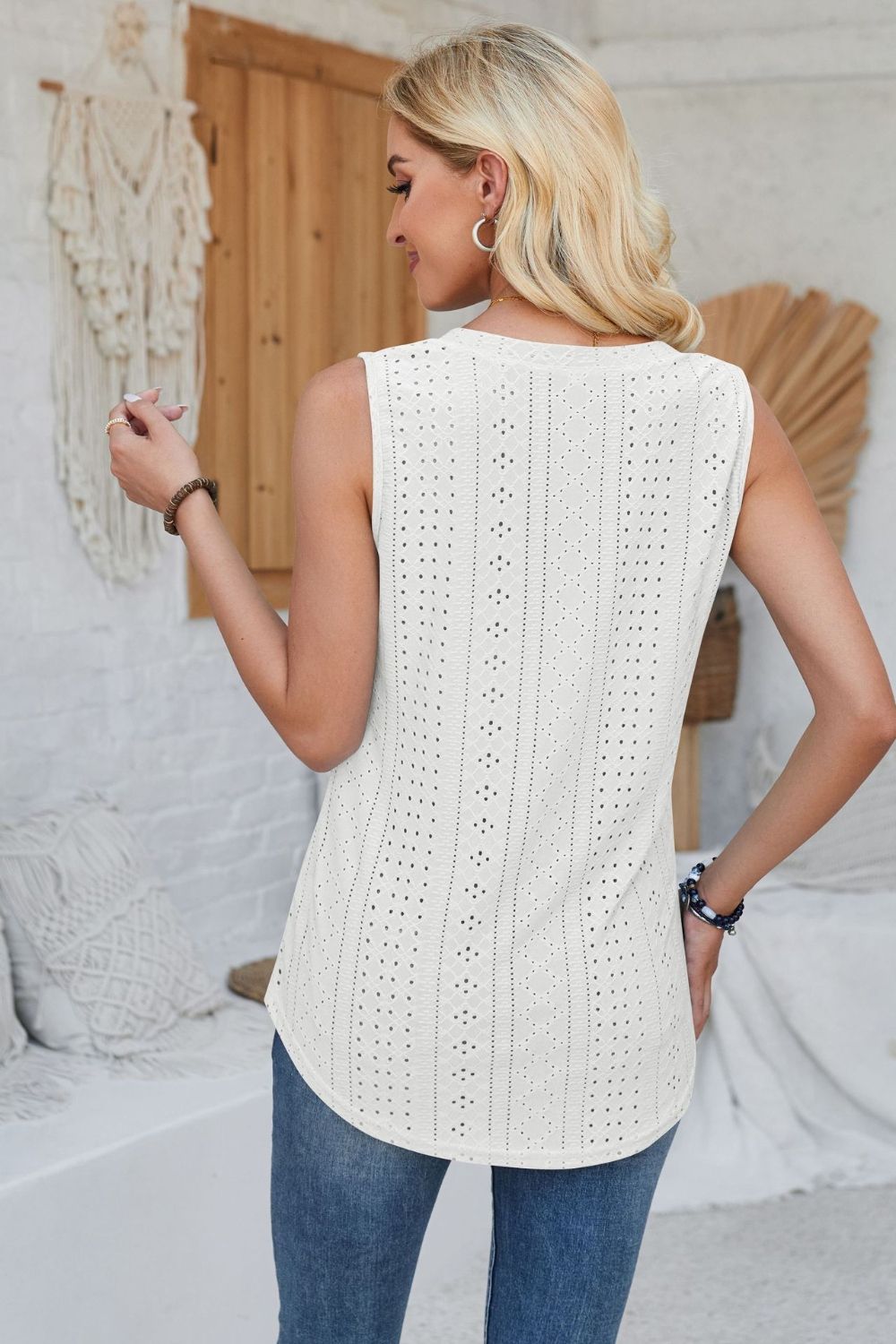 White perforated button-down sleeveless top with eyelet detail