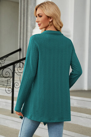 Turquoise textured knit cardigan with asymmetrical hem and long sleeves.