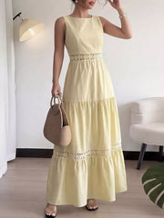Elegant yellow maxi dress with lace trim at the waist and hem, boat neckline, sleeveless.