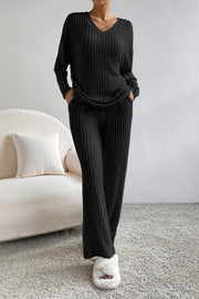 Black ribbed knit loungewear set with V-neck sweater and wide-leg pants.