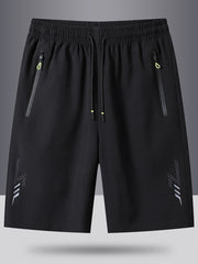 Men's black athletic shorts with drawstring, zip pockets, and reflective lightning detail.