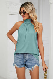 Teal halter neck blouse with gathered neckline and sleeveless cut.