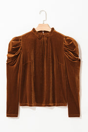 Brown velvet blouse with gathered puff sleeves and a mock neck.