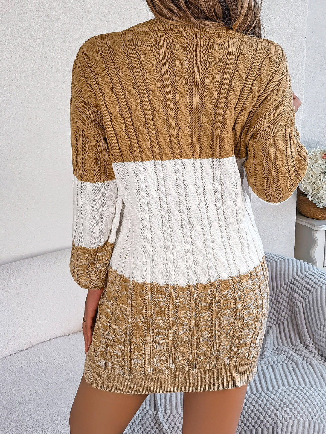 Colorblock cable knit mini dress in camel and white acrylic with a textured pattern.