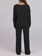 Black ribbed knit lounge set with long sleeves and wide-leg pants.